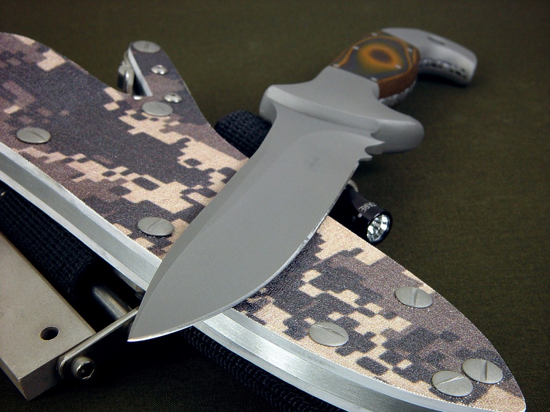 "Anzu" fine combat, tactical knife, obverse side view in CPMS30V high vanadium tool steel blade, 304 stainless steel bolsters, Tiger Stripe G10 fiberglass epoxy laminate composite handle, digi-camo desert kydex locking sheath with ultimate extender package and accessories