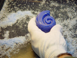 Wax carving by hand for the stand of "Aegir." The Nautilis is carved from a block of hard wax; you can see the flakes from the effort.