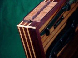 "Astarion" case corner detail. Note red lauan (Philippine Mahogany)  hinges, spline jointery in corners.