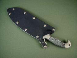 Sheathed view: "Horrocks" locking combat sheath is stainless steel, kydex, aluminum