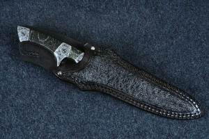 "Patriot" sheathed front view in CPM154CM high molybdenum powder metal technology martensitic stainless steel blade, hand-engraved 304 stainless steel bolsters, Golden Midnight Agate gemstone handle, Emu skin inlaid in hand-carved leather sheath