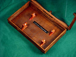 "The Veteran" display case. Case is poplar body, bloodwood hangers, and lauan wooden hinges with  glass front and engraved black lacquered brass