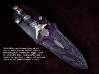 "Amethistine" dagger, obverse side view in 440C high chromium stainless steel blade, diffusion welded copper, nickel silver fittings, sterling silver gallery wire wrap and accents, Amethyst crystal gemstone pommel, hand-carved leather sheath inlaid with black rayskin